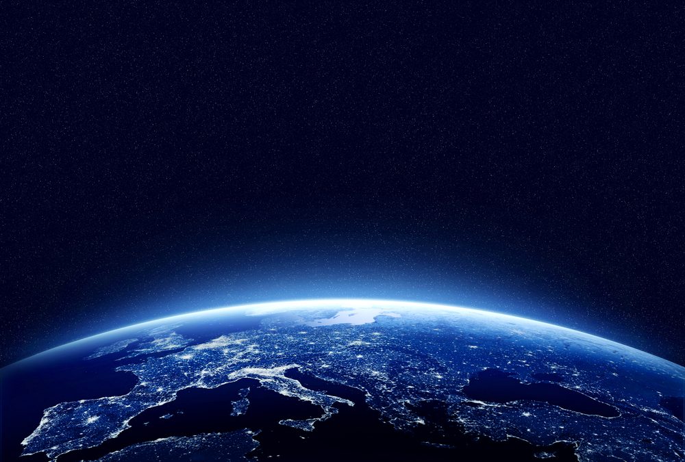 Earth at night as seen from space with blue, glowing atmosphere and space at the top. Perfect for illustrations. Elements of this image furnished by NASA